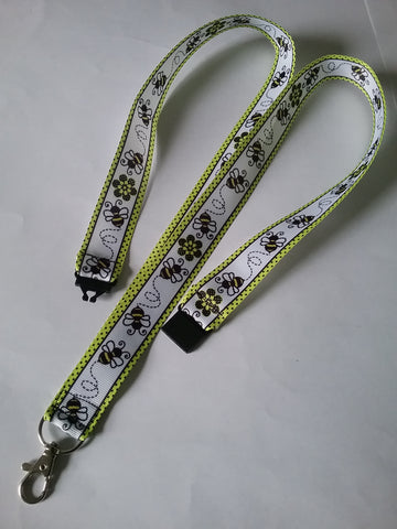 Honey bee with yellow border patterned ribbon lanyard made with a safety breakaway id or whistle holder with swivel lobster clasp
