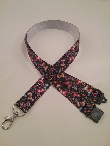 Coloured butterfly patterned ribbon lanyard made with a safety quick release breakaway id or whistle holder with swivel lobster clasp