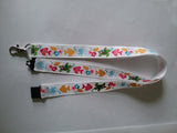 Lanyard made with white ribbon with lots of fish as the pattern it has a safety breakaway lanyard id or whistle holder - Tilly Bees