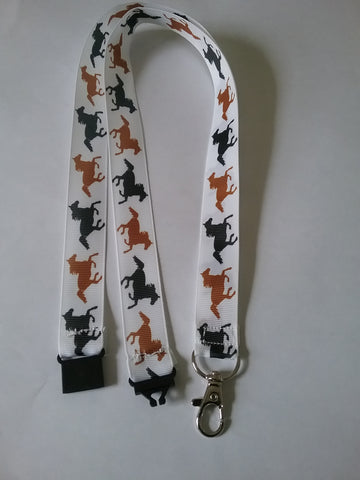 LANYARD Brown & Black horses on white ribbon patterned ribbon Lanyard it has a safety breakaway fastener with swivel lobster clasp for keys, id or whistle holder
