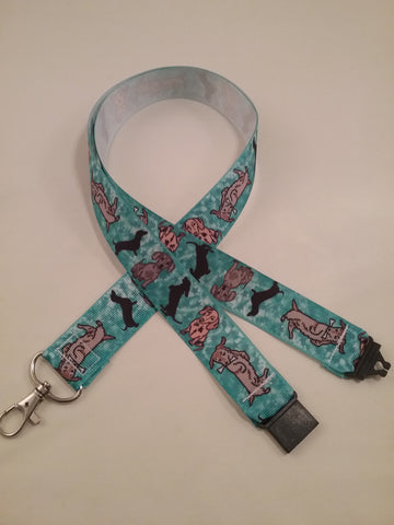 Turquoise blue cartoon dachshund patterned ribbon lanyard made with a safety breakaway id or whistle holder with swivel lobster clasp
