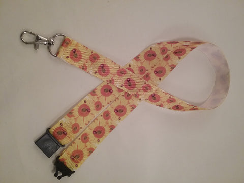 Sunflowers orange on yellow ribbon lanyard made with a safety quick release breakaway id or whistle holder with swivel lobster clasp