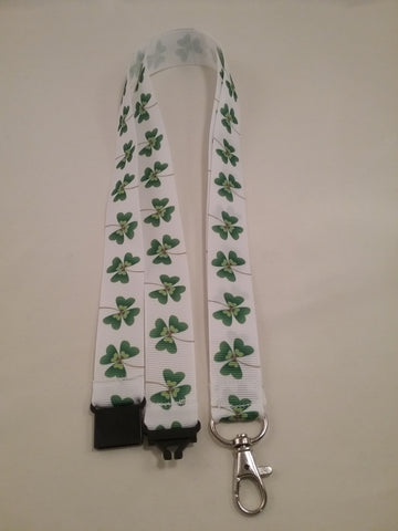 Clover on white ribbon lanyard made with a safety quick release breakaway id or whistle holder with swivel lobster clasp