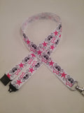 Skull & crossbones with pink bow & star on a white ribbon lanyard made with a safety quick release breakaway id or whistle holder with swivel lobster clasp - Tilly Bees