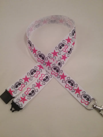 Skull & crossbones with pink bow & star on a white ribbon lanyard made with a safety quick release breakaway id or whistle holder with swivel lobster clasp