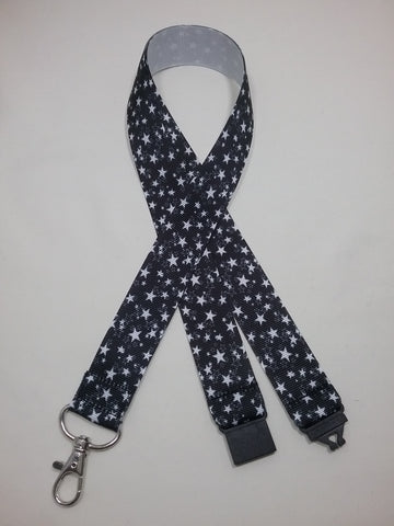 Black with white stars patterned ribbon Lanyard it has a safety breakaway fastener with swivel lobster clasp lanyard id or whistle holder