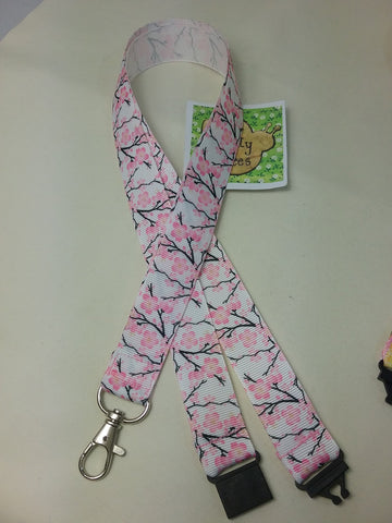 Cherry blossom white ribbon lanyard made with a safety quick release breakaway id or whistle holder with swivel lobster clasp